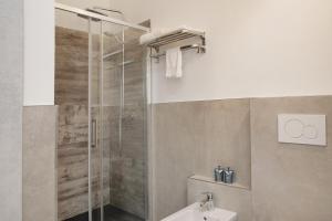 a bathroom with a shower and a sink at Appartamento Alice in Caiolo +18 photos