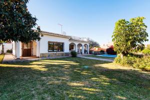 a house with a large yard in front of it at Best place Playamar in Torremolinos