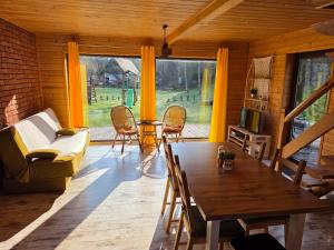 a living room with a table and a couch at Domki przy Młynie " Koło Młyńskie " in Krościenko