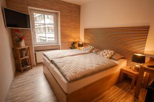a bedroom with a large bed and a window at Fewos Deutschherrenstraße in Trier