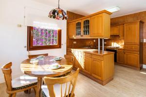 a kitchen with a wooden table and a dining room at Best place Playamar in Torremolinos