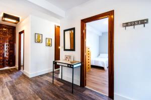 a room with a mirror and a table and a bed at Best place Playamar in Torremolinos