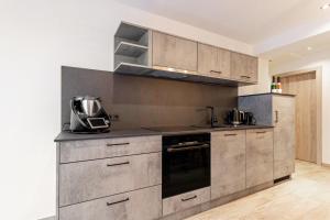 a kitchen with stainless steel cabinets and a stove at Grauzone Grossarl App Nr 1 Cozy in Grossarl