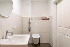 a white bathroom with a sink and a toilet at Zimis Hofnest in Freiamt +31 photos