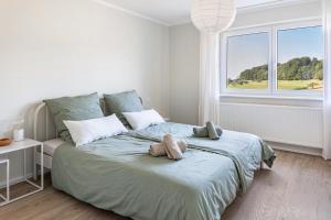 a bedroom with a bed with two stuffed animals on it at Zimis Hofnest in Freiamt