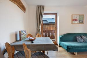 a living room with a table and a couch at Wohnung Schlern Heigler Hof in Collepietra