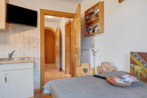 a room with a kitchen with a bed and a sink at Wohnung Schlern Heigler Hof in Collepietra