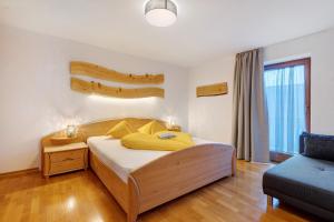 a bedroom with a large bed and a couch at Wohnung Schlern Heigler Hof in Collepietra
