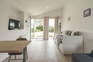 a living room with a couch and a table at Au petit chez nous in Cozes