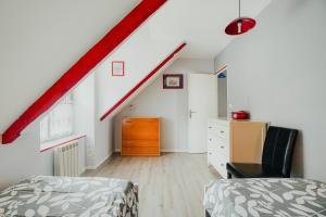 a attic room with a bed and a staircase at Gite Les Dauphins à Matignon in Matignon