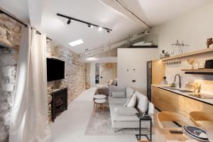 a living room with a couch and a fireplace at Cozy Sommavilla Residence in Brenzone sul Garda