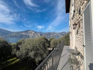 a balcony with a view of a lake and mountains at Cozy Sommavilla Residence in Brenzone sul Garda