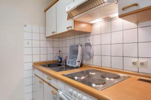 a kitchen with a stove and a sink at Fewo Kessler Schwarzwaldstüble in Häusern