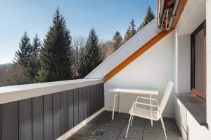 a balcony with a table and chairs on a roof at Fewo Kessler Schwarzwaldstüble in Häusern