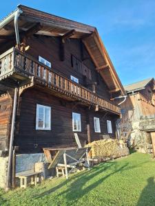 a large wooden house with a deck on the side of it at Adlerhütte in Stall