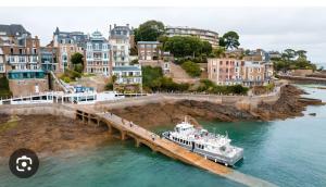 a boat is docked at a dock in the water at Le Cocon De Laurence in Pleurtuit
