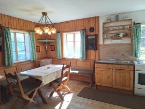 a kitchen with a table and a table and chairs at Adlerhütte in Stall
