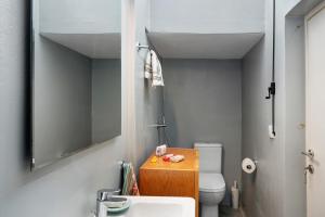 a small bathroom with a sink and a toilet at Livadi House Amorgos in Aegiali +23 photos