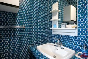 a blue tiled bathroom with a sink and a mirror at Villa Ker Louise in Locquirec +23 photos