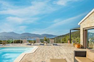 a house with a swimming pool and a patio at Villa Kalliste in Olmeto +3 photos
