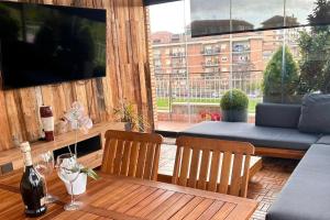 a patio with a table and chairs and a large window at Fiorucci Apartments - Veronica's House in Rome