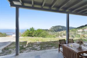 a view of the ocean from the patio of a house at Villa Andreas in Athani