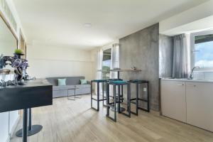 a kitchen and living room with a couch and a table at Villa Andreas in Athani