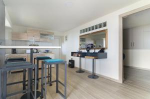 a kitchen with two bar stools and a mirror at Villa Andreas in Athani +16 photos
