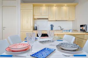 a kitchen with a table with plates and bowls on it at Casa Ioana in Cugnana Verde