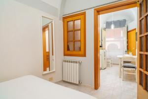 a bedroom with a bed and a desk in a room at Casa Idda in Linguaglossa