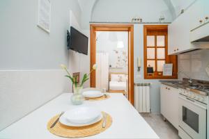 a kitchen with a table with plates on it at Casa Idda in Linguaglossa +15 photos