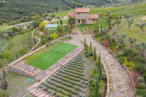 an aerial view of a house with a golf course at Le Sughere in Riparbella