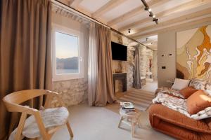 a living room with a couch and a fireplace at Cozy Sommavilla Residence in Brenzone sul Garda