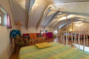 a bedroom with a bed and a couch in a room at La Casita in Beauvène