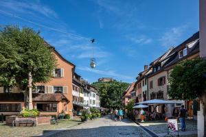 a street in a town with people walking down a street at Ferienwohnung am Neumagen in Staufen im Breisgau