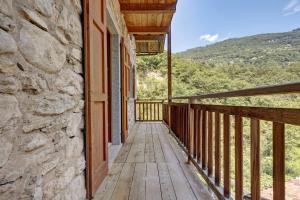 a balcony of a house with a wooden walkway at Casa al Mulino 1 in Tenno