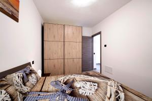 a bedroom with a large bed and white walls at Appartamento 1 Il Tornante in Nesso +20 photos