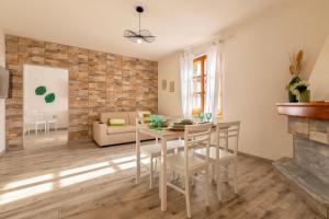 a kitchen and living room with a table and chairs at Casa Belvedere in Codrongianos +15 photos