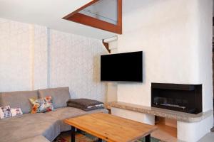 a living room with a couch and a flat screen tv at Nini´s Berge in Sonthofen