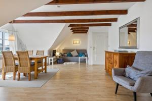 a kitchen and living room with a table and chairs at Fewo Silbermöwe in Pellworm