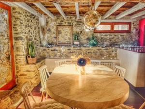 a dining room with a wooden table and chairs at Le Grand Mas de Can Noy in Montferrer