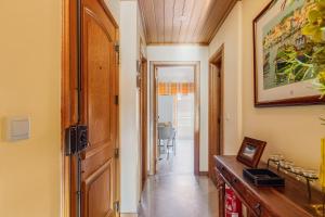 a hallway of a home with a wooden door at Setúbal Dreams in Setúbal