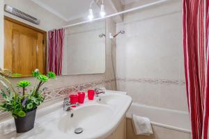 a bathroom with a sink and a mirror and a tub at Setúbal Dreams in Setúbal +23 photos