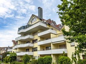 a yellow building with a chimney on top of it at Appartement Seefreunde in Langenargen