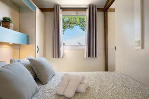 a bedroom with a bed with two towels on it at La Breña in Barbate +17 photos
