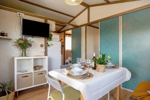 a dining room with a white table and chairs at La Breña in Barbate