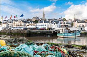 a group of nets in the water near a city at La Voile Blanche - 36 in Pornic