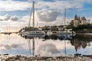 a group of boats docked in a body of water at La Voile Blanche - 36 in Pornic +2 photos