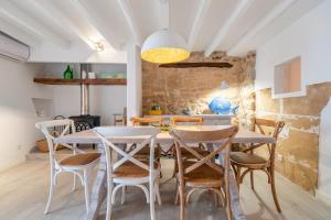 a dining room with a table and chairs at Casa La Roca in Pollença