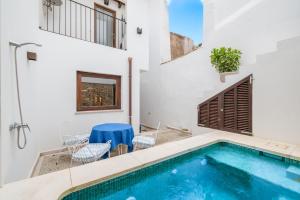 a swimming pool in the middle of a house at Casa La Roca in Pollença
